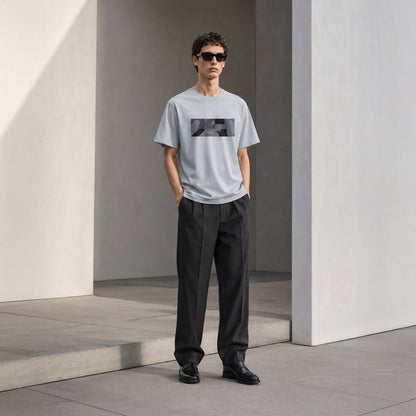 USA CREATES 250 Icon Block Tee Neutral, cement colorway worn by a man with sunglasses in a clean architectural editorial portrait