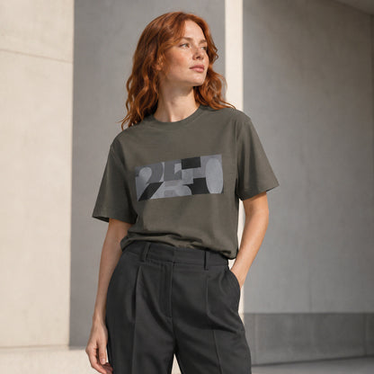 USA CREATES 250 Icon Block Tee Neutral, flint colorway worn by a woman with red hair in a minimal outdoor editorial portrait