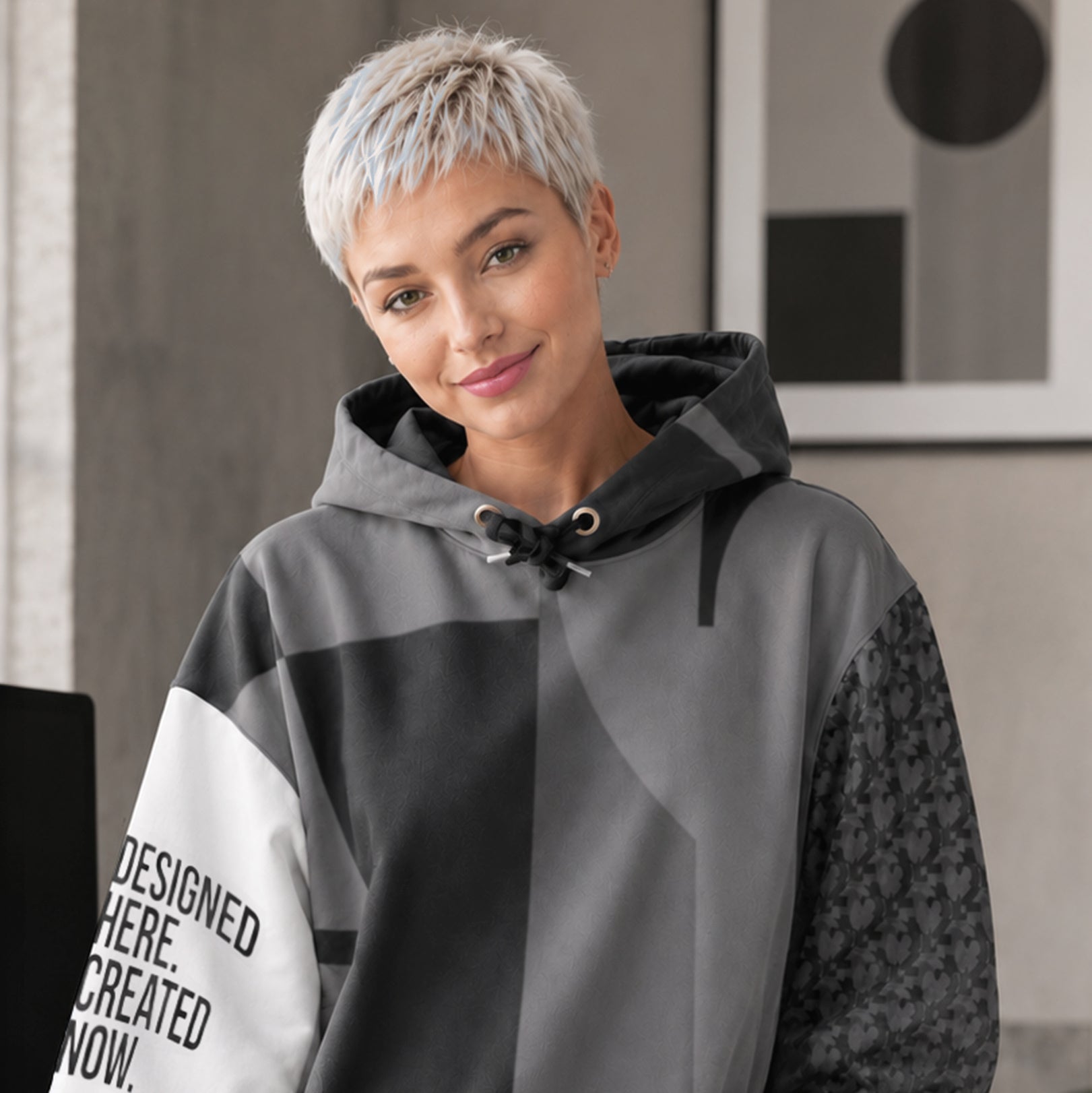 USA CREATES 250 Icon Hoodie Neutral, tonal gray color-block hoodie worn by a woman with short silver hair in an interior editorial portrait