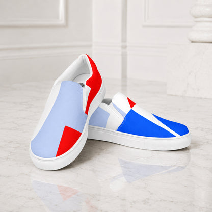 USA CREATES 250 Icon Women's Slip-On RWB, pair of RWB color-block slip-on shoes on a white marble surface, angled front view showing blue and red geometric design