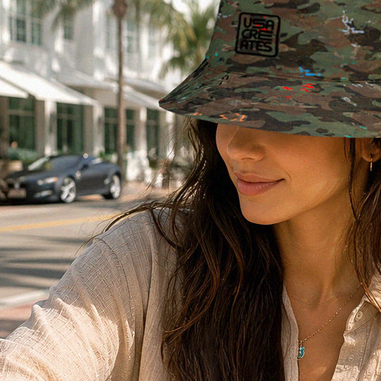 USA CREATES Camo Reversible Bucket Hat, shown in sunny street editorial styling with Camo Color pattern side