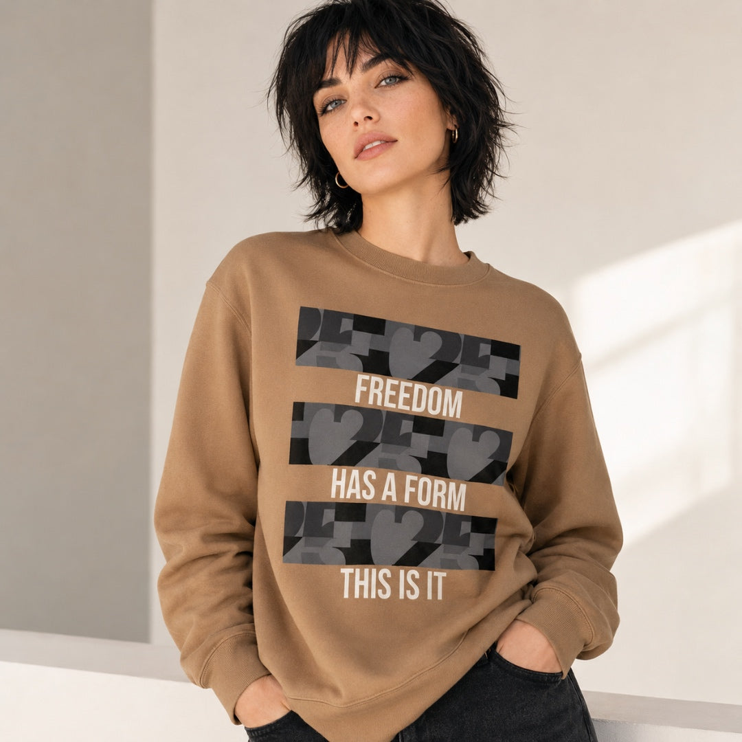 USA CREATES Freedom Form Sweatshirt, sand colorway with bold Freedom Has a Form graphic worn by a woman in a clean minimal editorial portrait